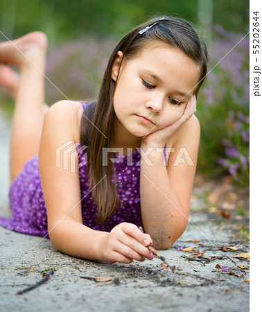 Girl is laying on forest road and drawing Girl is laying on forest road and drawing 55202644