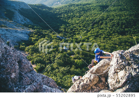 Woman climbing mountain.  55202895