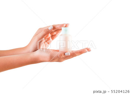 Female hand holding cream bottle of lotion 55204126