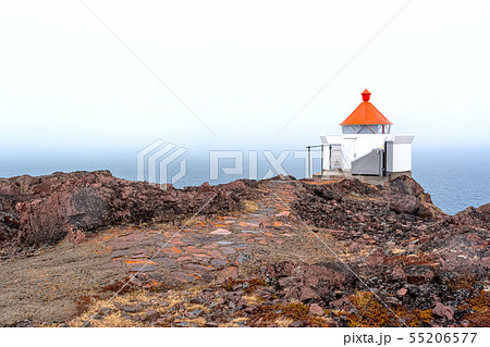 The sea beacon with a red top and a stone footpath The sea beacon with a red top and a stone footpath 55206577