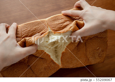 食パンを割る様子 女性手元 55209067