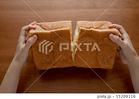 食パンを割る様子 女性手元 55209116