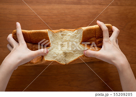 食パンを割る様子 女性手元 55209205