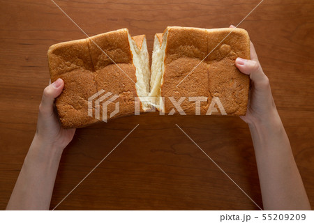 食パンを割る様子 女性手元 55209209