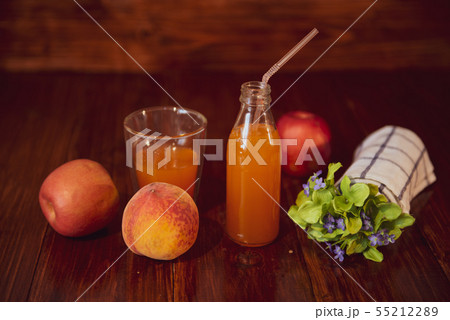 Fresh juice in bottle on wooden table 55212289