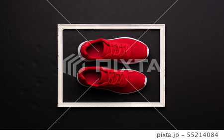 A studio shot of pair of running shoes on black background. Flat lay. 55214084