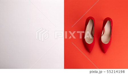 A studio shot of pair of high heel shoes on color background. Flat lay. A studio shot of pair of high heel shoes on color background. Flat lay. 55214198