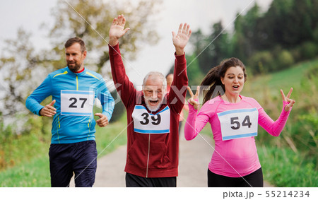 Large group of multi generation people running a race competition in nature. 55214234