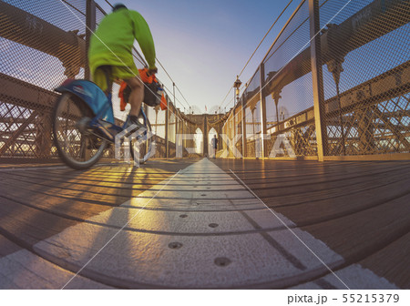 a magnificent view of Brooklyn Bridge with cyclist a magnificent view of Brooklyn Bridge with cyclist 55215379