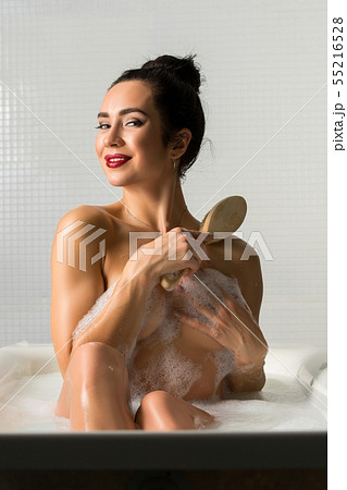 Nude brunette with massage brush view 55216528