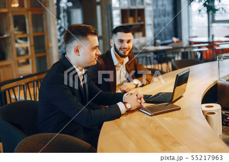 Two businessmen working in a cafe 55217963