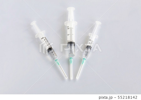 Several different syringes on a white smooth table 55218142
