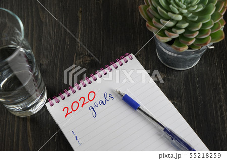 Top view of notebook with text 2020 goals and to Top view of notebook with text 2020 goals and to 55218259