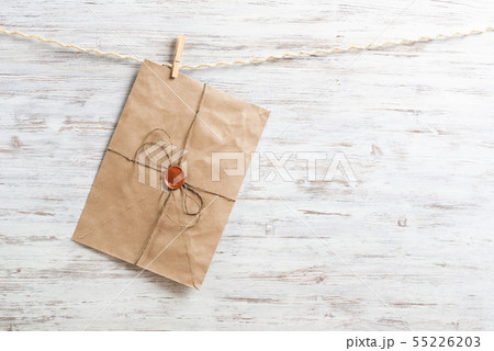Old paper envelope hanging on rope 55226203