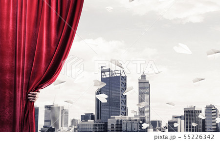 Modern business cityscape behind curtain opened by businessman hand Modern business cityscape behind curtain opened by businessman hand 55226342