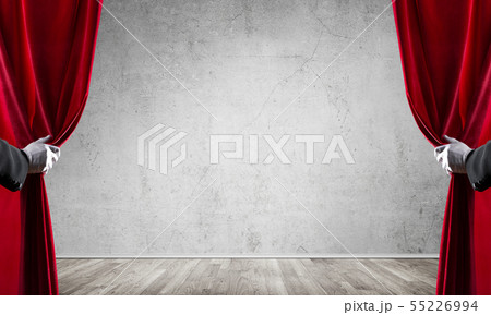 Concrete wall behind drapery curtain and hand opening it Concrete wall behind drapery curtain and hand opening it 55226994