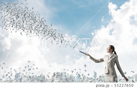 Smiling woman looking at flying out random letters Smiling woman looking at flying out random letters 55227650