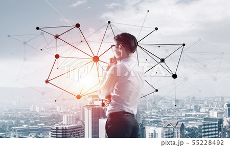 Concept of business success and control with confident boss against cityscape background Concept of business success and control with confident boss against cityscape background 55228492