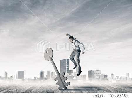 Breaking through access concept with furious man crashing concrete key 55228592
