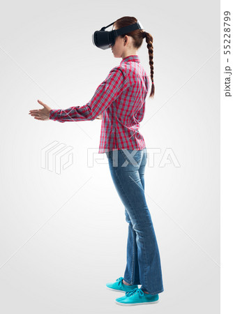 Young woman wearing VR goggles 55228799