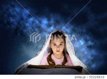 Little girl reading book in bed Little girl reading book in bed 55228810