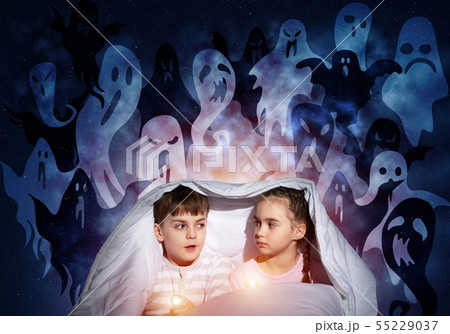 Scared girl and boy with flashlighst 55229037