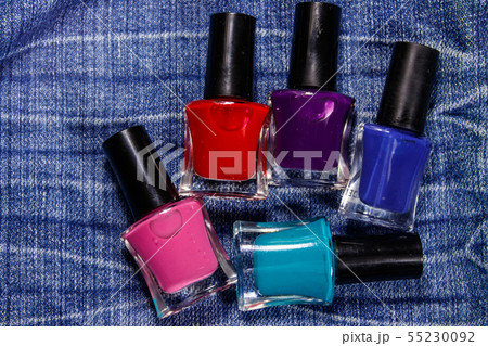 Set of nail polish bottles on jeans background 55230092