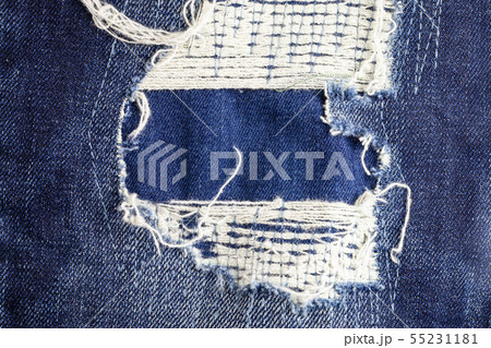 Blue torn denim jeans texture background. 55231181
