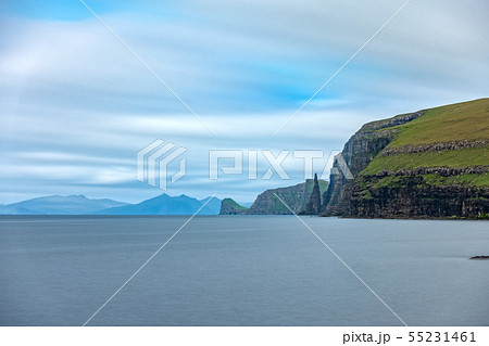 Sandoy rock needle in the steep coastline, long exposure Sandoy rock needle in the steep coastline, long exposure 55231461