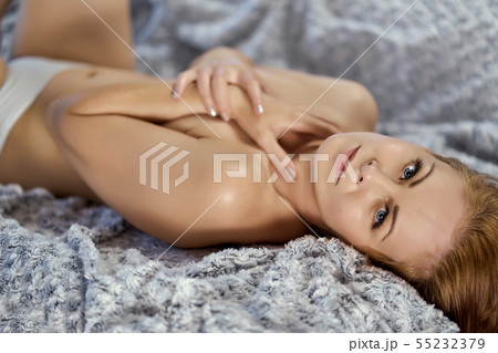 attractive beautiful half naked woman posing on the sofa 55232379