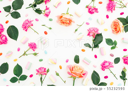 Frame with rose flowers and bright sugar candy Frame with rose flowers and bright sugar candy 55232593