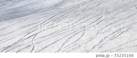 Snowy ski slope for freeride with trace from skis 55235100