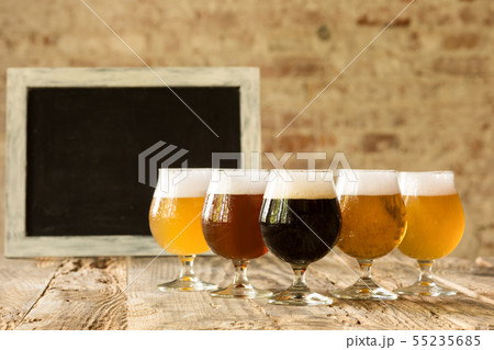 Glasses of different kinds of beer on wooden background 55235685