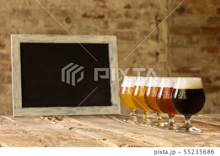 Glasses of different kinds of beer on wooden background 55235686