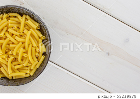 Raw macaroni pasta on grey wood 55239879