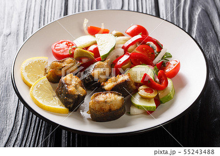 Slices of fried eel fish with fresh vegetable 55243488
