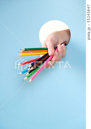 Human hand protruding through hole in blue Human hand protruding through hole in blue 55243647