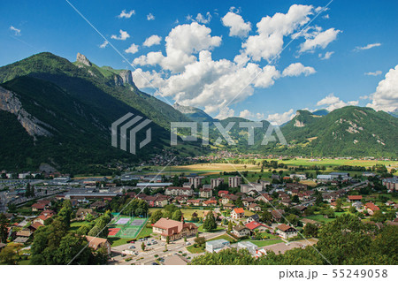 Houses in valley with green mountains and blue sky Houses in valley with green mountains and blue sky 55249058