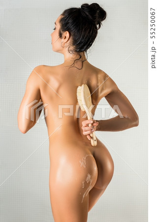 Nude brunette with massage brush rearview Nude brunette with massage brush rearview 55250067