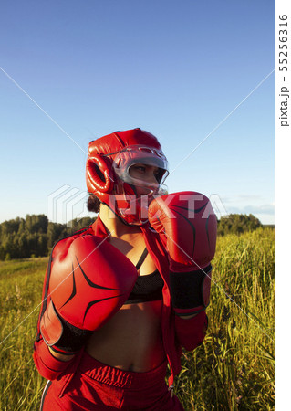 pretty swag indian girl training box outside in green field. lifestyle sporty people concept 55256316