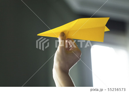 Hand holding paper airplane Hand holding paper airplane 55256573