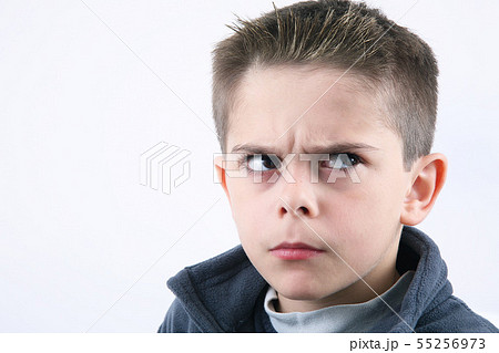 angry young boy in white background 55256973