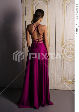 Beautiful girl in long classic red dress posing 55258611