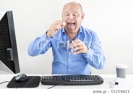 Businessman taking pills for headache Businessman taking pills for headache 55259823