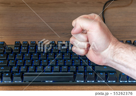 man fist hitting the keyboard 55262376