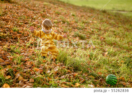 Happybaby boy laughing and playing with green ball Happybaby boy laughing and playing with green ball 55262836