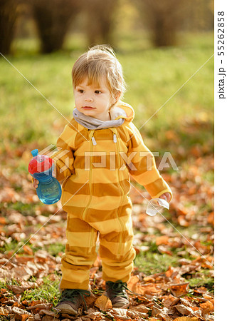 Happy little boy with water bottle playing in the Happy little boy with water bottle playing in the 55262858