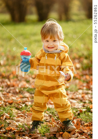Happy little boy with water bottle playing in the Happy little boy with water bottle playing in the 55262861