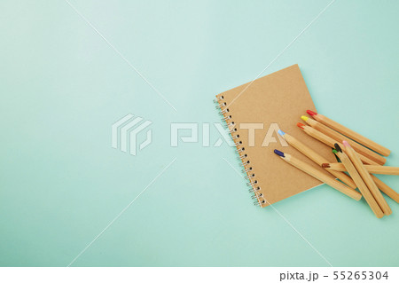Crayon With a notebook on blue Crayon With a notebook on blue 55265304