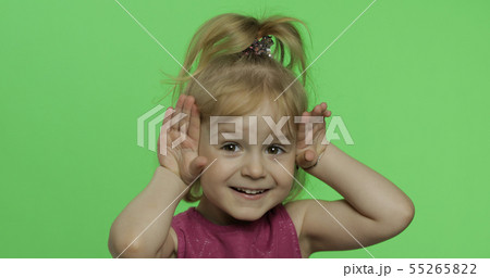 Positive blonde girl portrait in purple dress. Pretty blonde child. Chroma Key 55265822